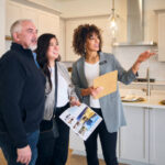 A professional real estate agent, showing a new home to prospective buyers.