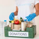 volunteer-with-gloves-handling-box-food-donations_23-2148733759