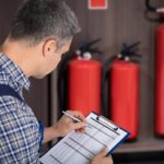 professional-checking-fire-extinguisher_1016675-4027