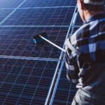 af man-worker-firld-by-solar-panels