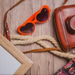frame-sunglasses-camera-wooden-surface (1) (1)