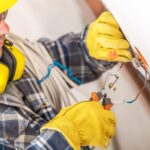 electrician-working-on-wiring-installation-in-a-residential-setting-during-daylight-hours