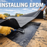 Installing EPDM rubber roofing on a flat roof, showing adhesive application and EPDM membrane positioning