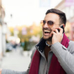 Handsome man speaking on the phone outside