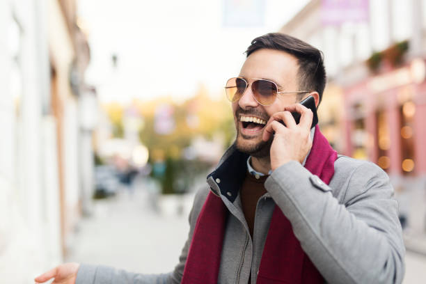 Handsome man speaking on the phone outside