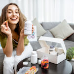 Woman with nutritional supplements at home
