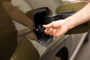 closeup-man-opening-ev-vehicle-inlet-port-attach-electric-cable (2) (1)