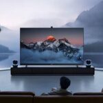 A modern living room featuring a large ultra-HD television displaying a mountain landscape, showcasing the Strong 8K IPTV Player experience with immersive 8K streaming, cinematic visuals, smart entertainment technology, and premium home viewing comfort.
