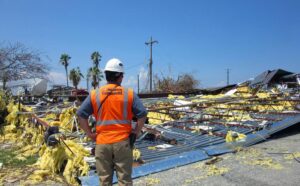 Structural engineers conducting rapid damage assessment in engineering for catastrophe response after a major hurricane, showcasing drone survey, shoring supports, and resilient rebuilding concepts