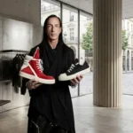 Rick Owens holding brand sneakers