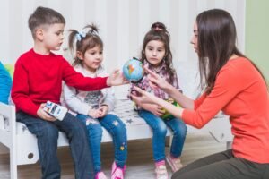 children-learning-globe-with-woman-bedroom (1) (1)