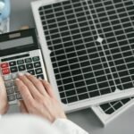 close-up-hand-typing-calculator-scaled