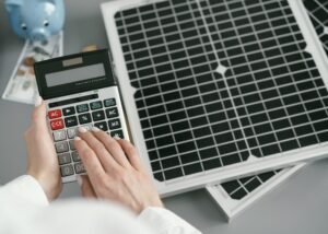 close-up-hand-typing-calculator-scaled