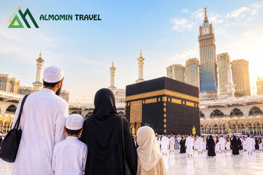 Muslim family standing together in front of the Kaaba in Makkah with Al Momin Travel logo.
