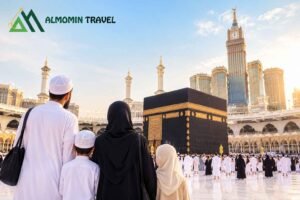 Muslim family standing together in front of the Kaaba in Makkah with Al Momin Travel logo.