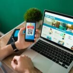 young-man-using-discount-coupon-his-smartphone-some-online-shopping-laptop_662251-2177