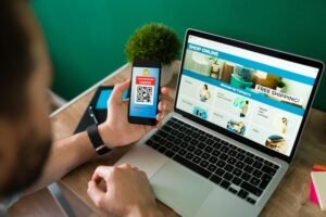 young-man-using-discount-coupon-his-smartphone-some-online-shopping-laptop_662251-2177